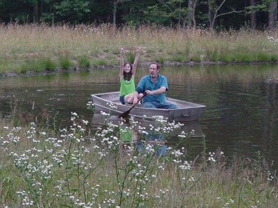 Mark and Cyann in the john boat on the pond