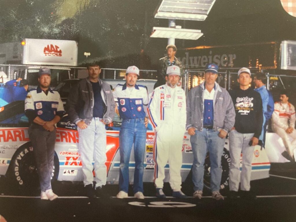 Tom Sherrill with his number 7 race car and crew in victory lane